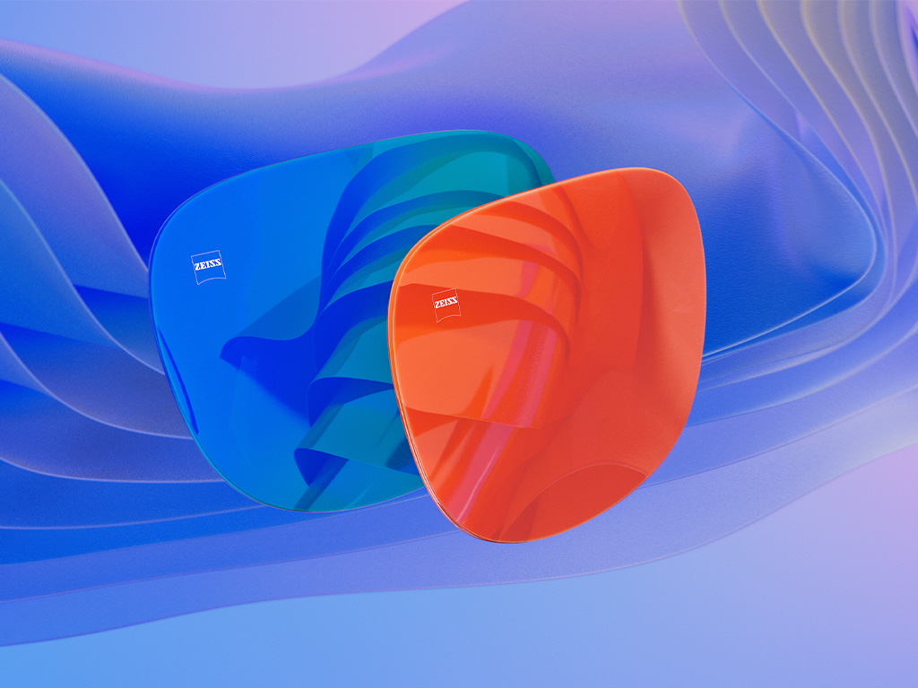 블루 및 오렌지 미러 코팅이 적용된 두 개의 선글라스 렌즈를 보여주는 3D 컴퓨터 일러스트레이션입니다.