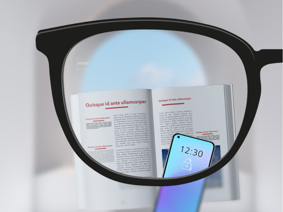 자이스 스마트라이프 단초점 렌즈의 시점으로 본 모습. 스마트폰과 책이 보이고 렌즈가 완전히 선명하다.